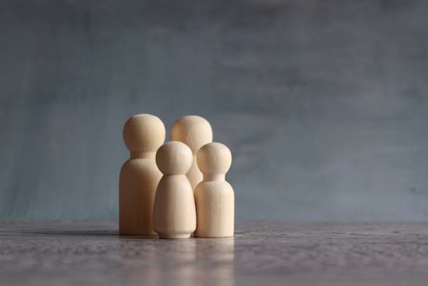 Family wooden dolls on wooden table with copy space. stock photo