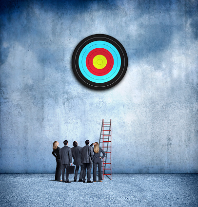 A group of business people look up at a target above them as they realize that their ladder is too short.