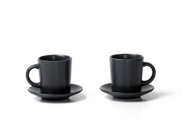 istock Close-up of two identical coffee tea cups with a saucer on a white background 1410127343