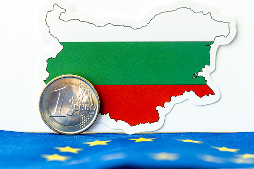 The flag of Bulgaria and the euro coin, standing against the background of the symbol of the European Union, Creative concept, the adoption of the common European currency by the Bulgarians