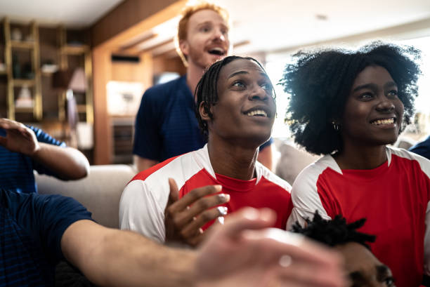 istock Sports fans watching a match at a house 1410130173