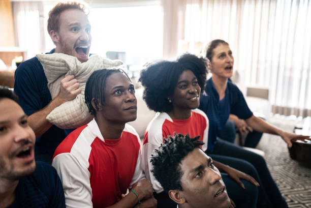 istock Sports fans watching a match at home 1410130210