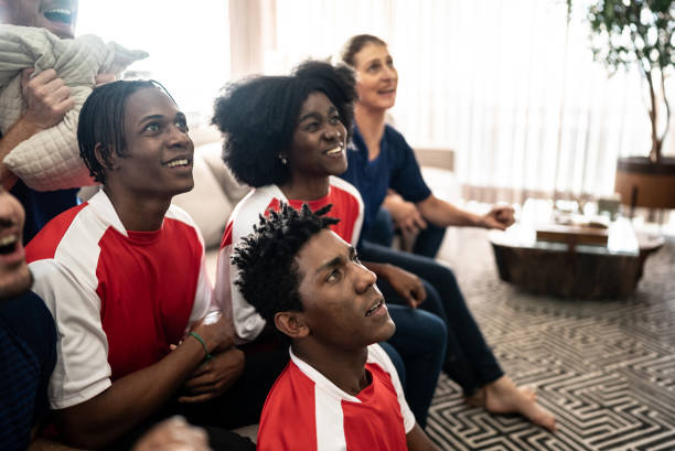 istock Sports fans watching a match at home 1410130213