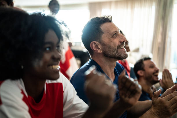 istock Friends watching soccer team playing a match at home 1410130823