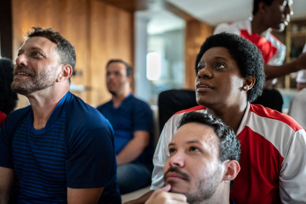 istock Friends watching soccer team playing a match at home 1410130828