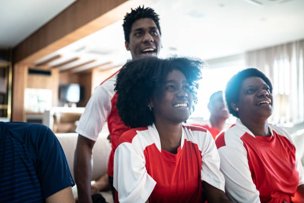 istock Friends watching soccer team playing a match at home 1410130882