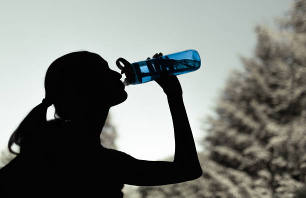 Woman drinking water.