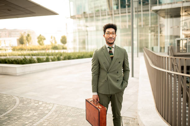 istock African American businessman with suitcase looking at camera 1410131752
