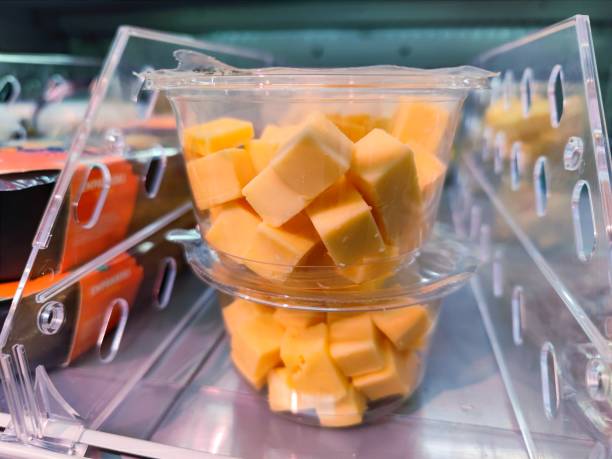 istock Plastic container with cubes of cheese in it is being sold without visible marks or brands on a supermarket shelf 1410132805