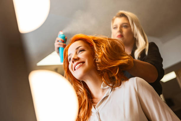 istock Hairdresser using hairspray 1410133393