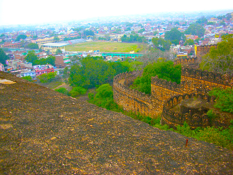 This image showcases the Reis Magos Fort, a historical landmark located along the banks of the Mandovi River in Goa. The fort, known for its distinctive red-laterite walls and rugged architecture, stands as a testament to Goa's rich colonial past. In the photograph, the fort's imposing structure is captured against the backdrop of the lush Goan landscape and the expansive river. The image aims to convey the historical significance of the Reis Magos Fort, highlighting its role as a defensive stronghold and a cultural heritage site. It offers viewers a glimpse into the architectural splendour and strategic importance of this well-preserved fort, making it a captivating subject for those interested in the history and architecture of Goa.