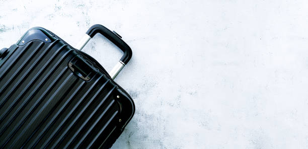 istock Black travel bag,Black luggage set on dark background, top view image, flat lay composition. Travel minimalist concept, black and dark classic baggage mockup, small and big. Suitcase accessory set, journey concept. 1410136611