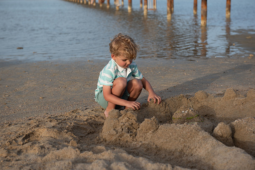 A boy is playing on the beach