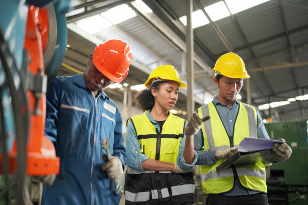 istock Three Diverse Multicultural Heavy Industry Engineers and Workers in Uniform at Steel Factory. 1410137912