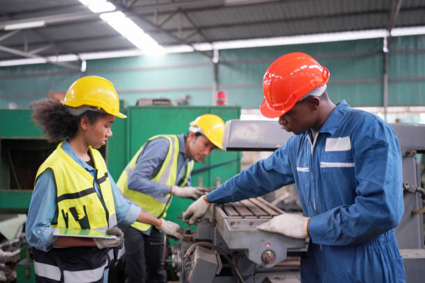 istock Three Diverse Multicultural Heavy Industry Engineers and Workers in Uniform at Steel Factory. 1410137930