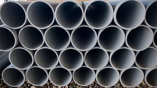 These pvc plumbing pipes  are in a stack ready to use at the construction site