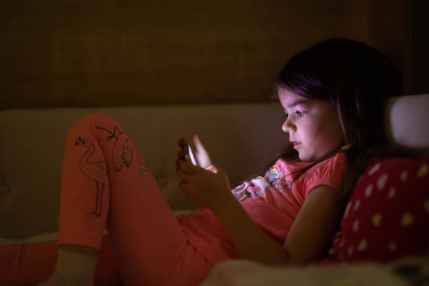 istock A cute little girl is using mobile phone 1410139327