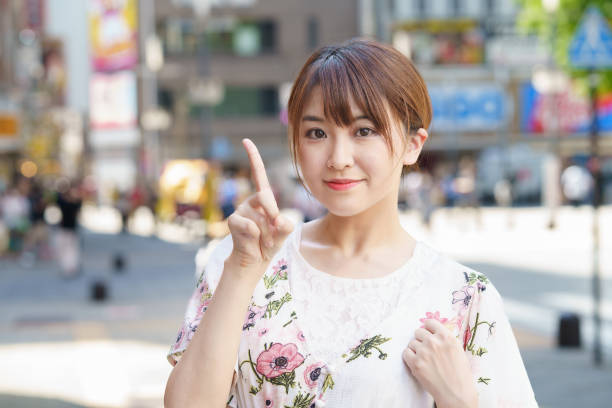 istock A woman posing to raise her index finger 1410140361