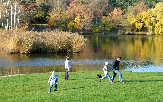 Warsaw, Poland - October 28, 2006: Family playing in the park