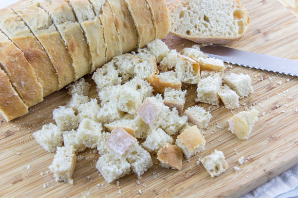 A loaf of bread being cubed. stock photo