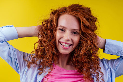 good mood concept. happy snow white smile redhead ginger woman feeling endorphins and love posing in studio over yellow background.
