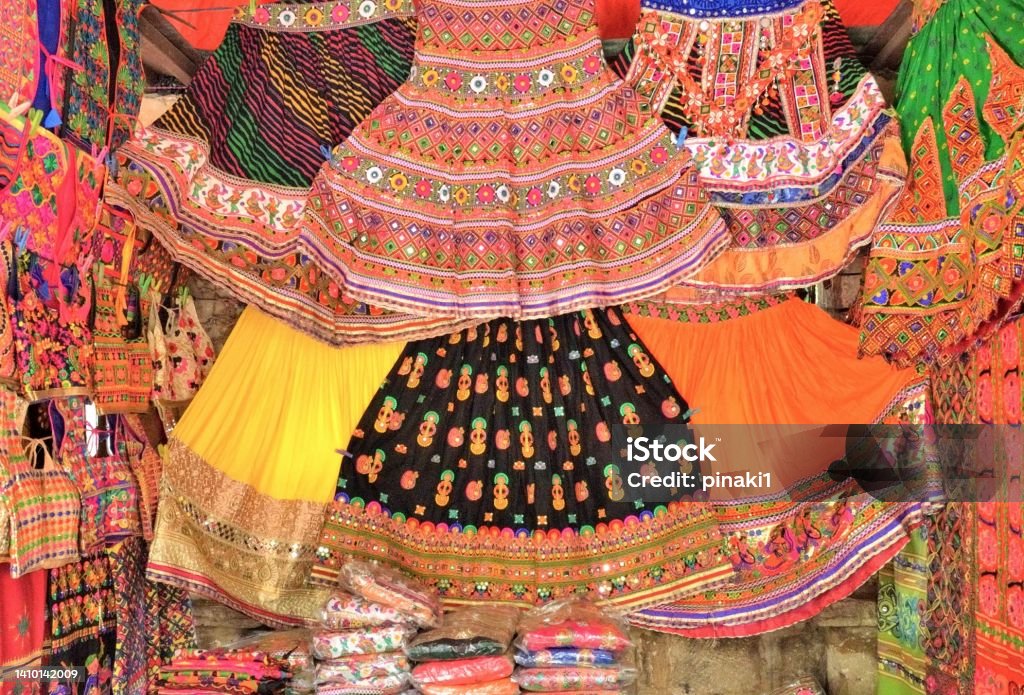 Colorful hand crafted Indian textile items on display at a store in Law Garden, Ahmedabad, Gujarat Colorful traditional hand crafted Indian textile items on display at a store in Law Garden, Ahmedabad, Gujarat in India Art Stock Photo