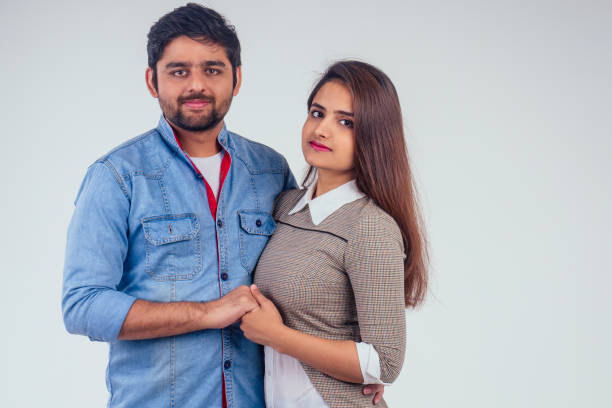 istock indian couple in love posing at studio white background 1410142169