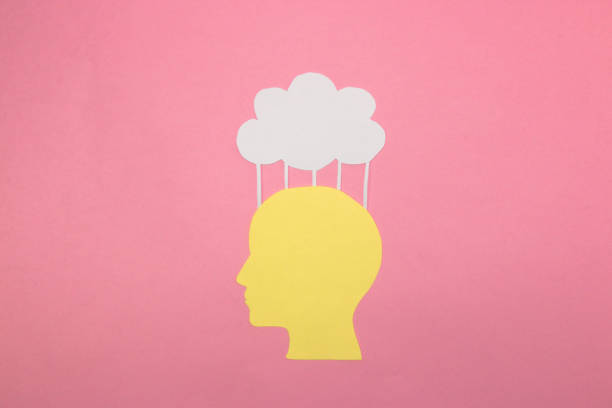 istock yellow paper people head that uploads content to the cloud, creative art design, artificial intelligence, a combination of man and technology, a cloud replacement for the brain 1410144645