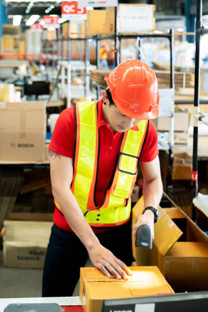 istock Worker Scanning Package In Warehouse for shipping at warehouse factory. 1410145293