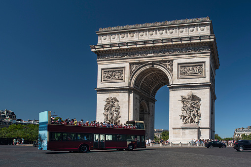 Arc de Triomphe in Paris with a tourist bus in France on the Champs Elysées