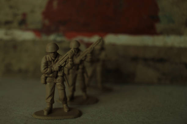 istock Toy soldiers with weapons on the red background 1410147897