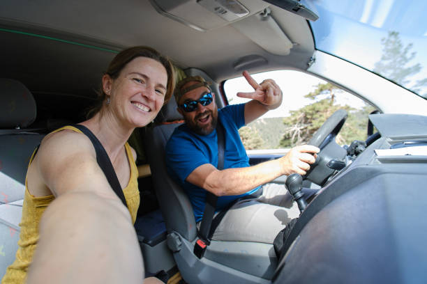 istock Positive couple taking selfie in car 1410147932