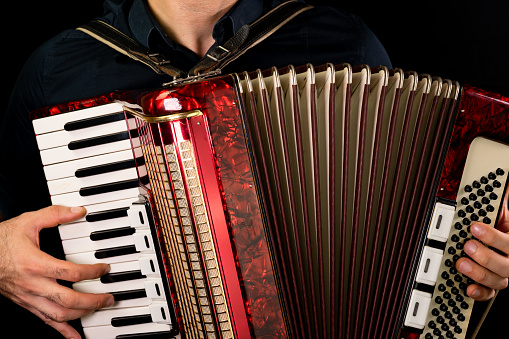 Man playing accordion with two hands