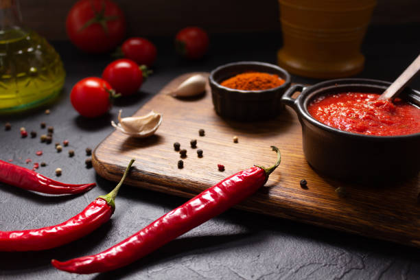 istock Chilly pepper and tomato sauce ingredient for homemade cooking at table 1410150254
