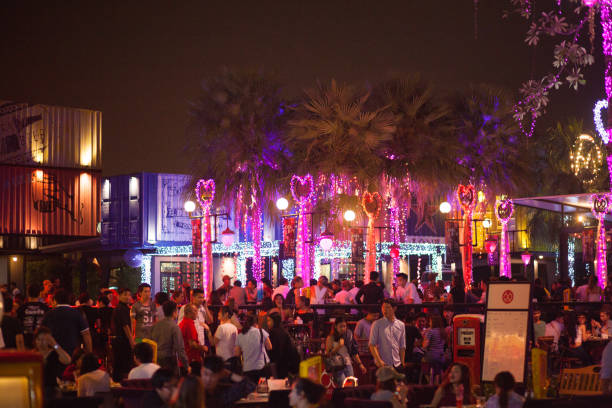 Crowded open bar and restaurant in Bangkok Nawamin. Many young and midaged thai people are visiting bar with open terrace and live music. Name is Station 66