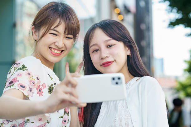 istock Two women taking selfies in the city 1410150587