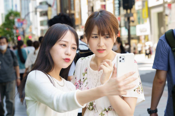 istock Two women taking selfies in the city 1410150699