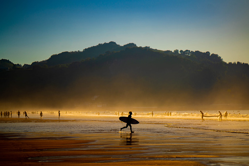 Silhouettes of people at the beach in Zarautz, Spain