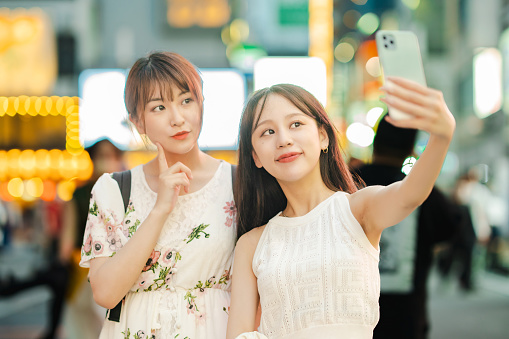 Young women taking selfies in downtown