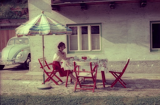 Bavaria, Germany, 1963. Outdoor breakfast table in front of a holiday home. Also: vacationer.