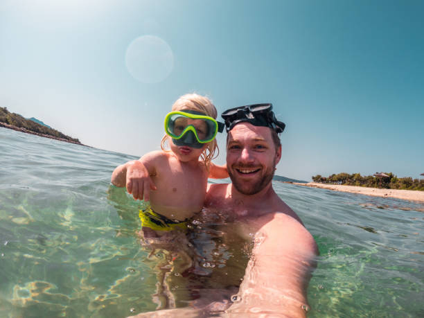 istock Caucasian Father and Son Using Googles Looking at Camera 1410154132