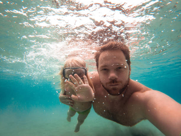 istock Beach Holiday, Underwater Fun Time Between Father and Son 1410154144