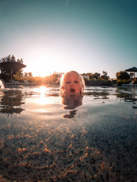 istock Boy Swimming in Pool with Only Head Out 1410154154