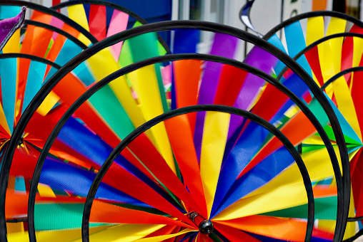 Colorful pinwheels outside a building at the beach.