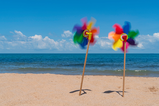 Sea, beach and colorful weather vane background. Taken with a full-frame camera in windy and sunny weather.