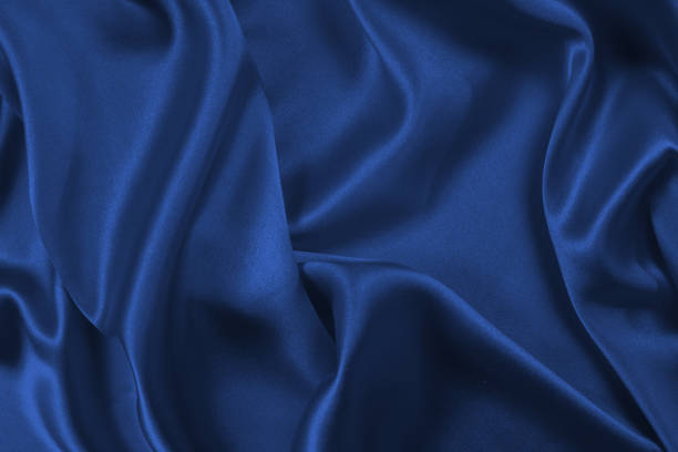 istock Rich and luxury red silk fabric texture background. 1410154934