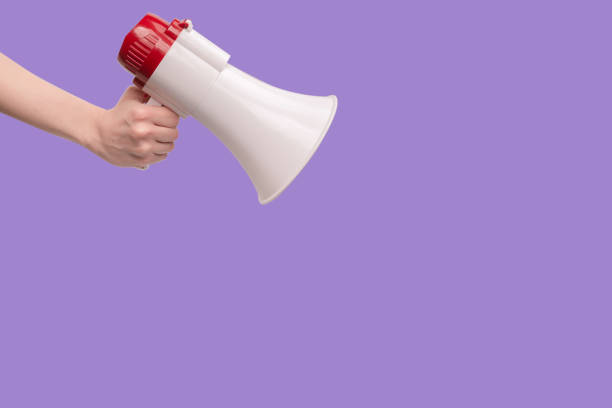 istock Megaphone in woman hands on a white background. 1410154939