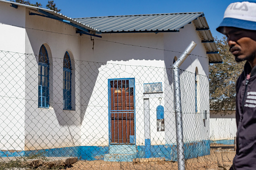 A man walking past a church building at Katutura Township near Windhoek at Khomas Region, Namibia