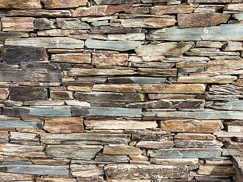 A wall of beautifully crafted stacked stone as a background.
