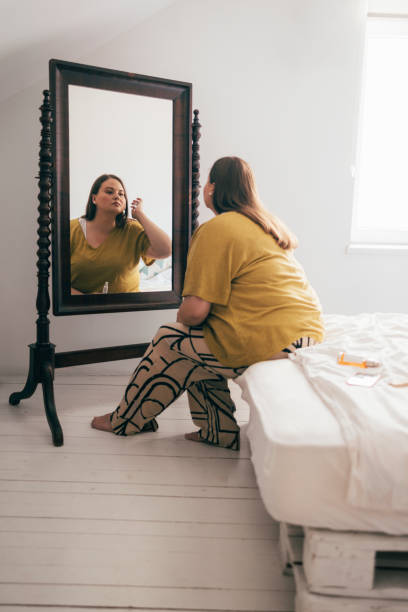 istock Woman Looking At Herself In The Mirror 1410160567